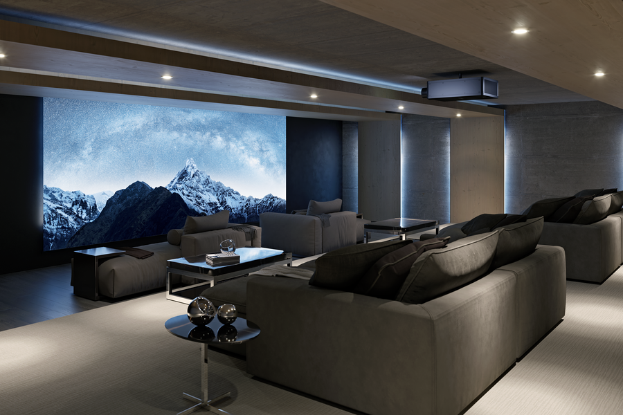 A luxury home theater with low lighting, two rows of seating, and a mountain scene on screen.
