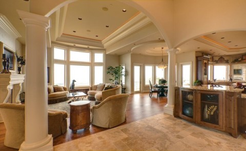 A large, open living space featuring in-ceiling speakers for a whole-home audio system.
